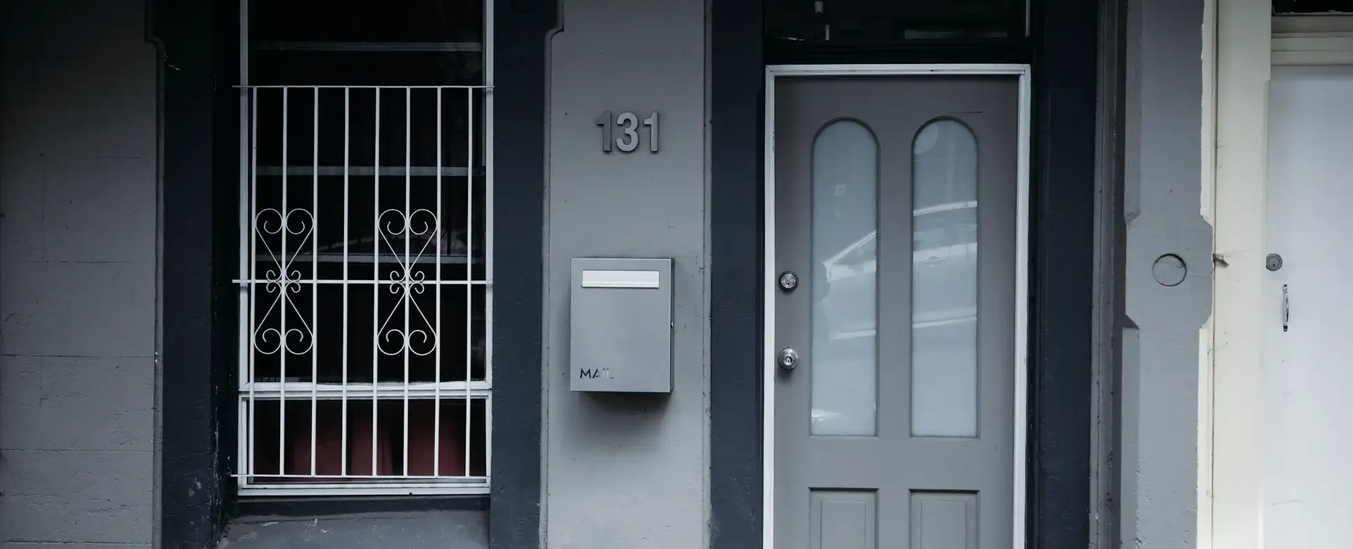 The front door and window of a terrace house