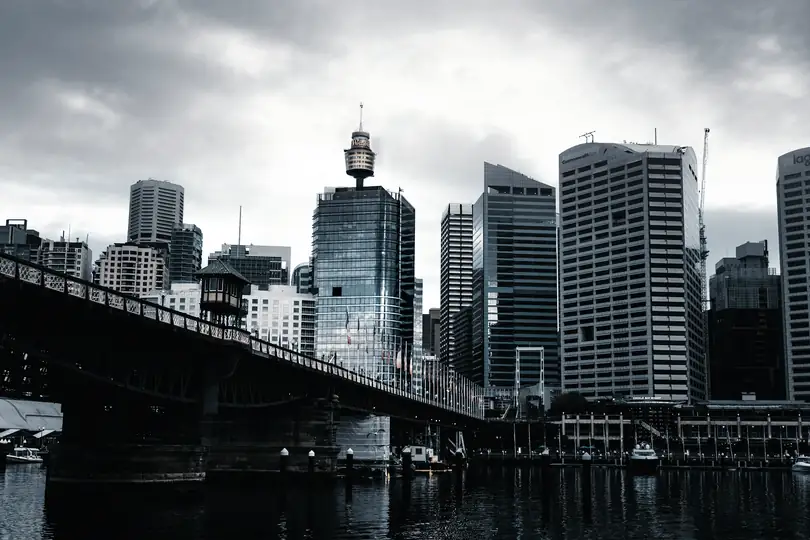 City towers beside an old iron bridge
