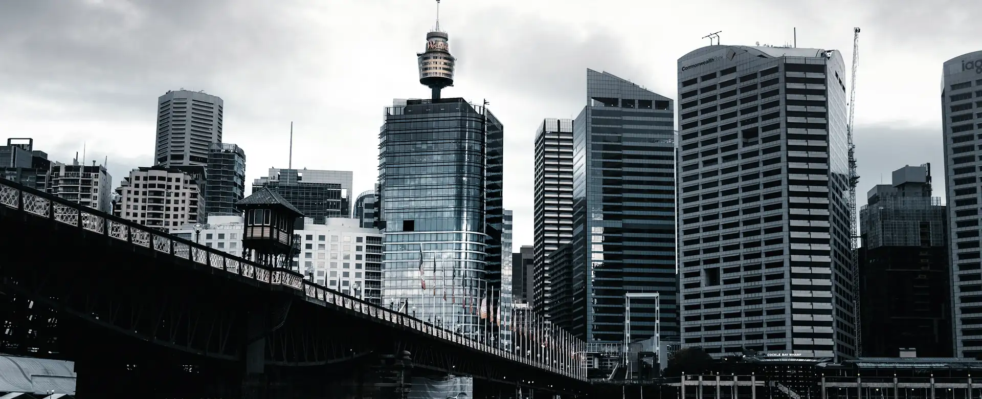 City towers beside an old iron bridge
