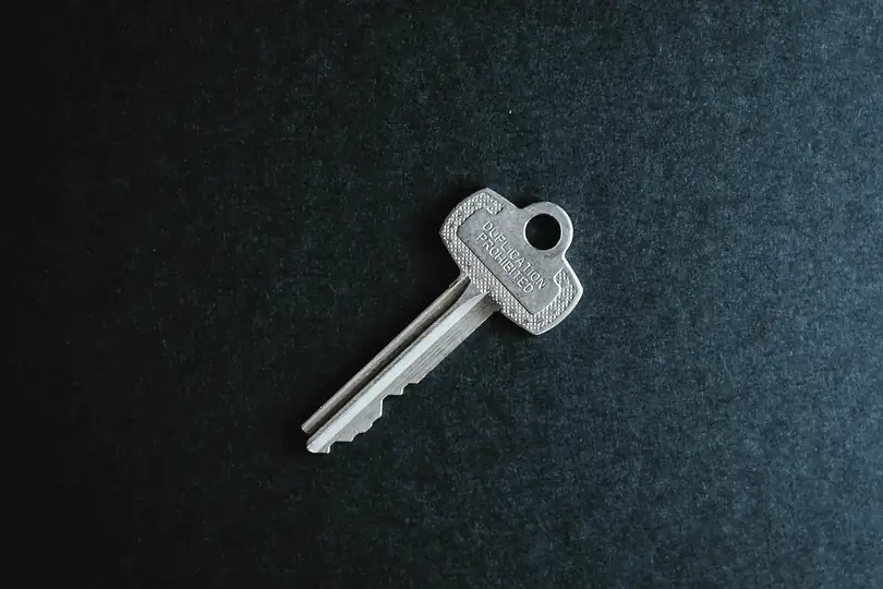 A single key on a dark surface