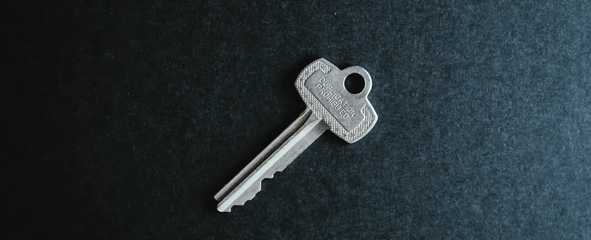 A single key on a dark surface