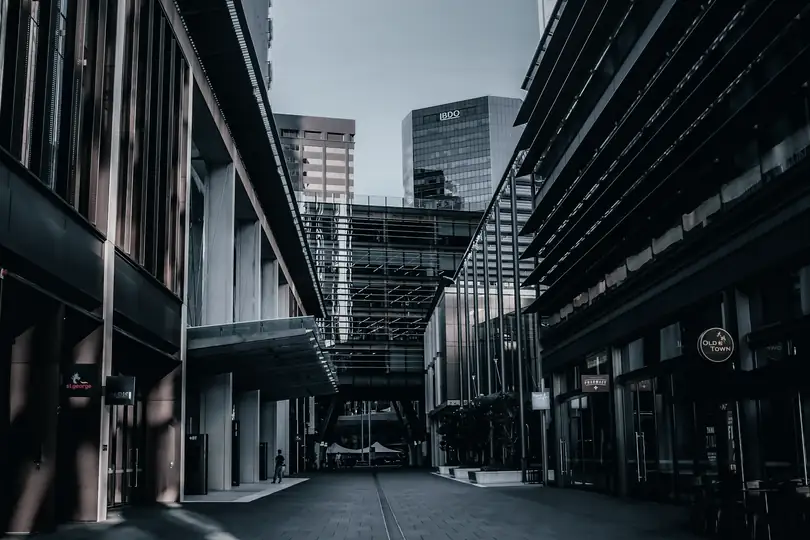 A city lane running between tall office buildings