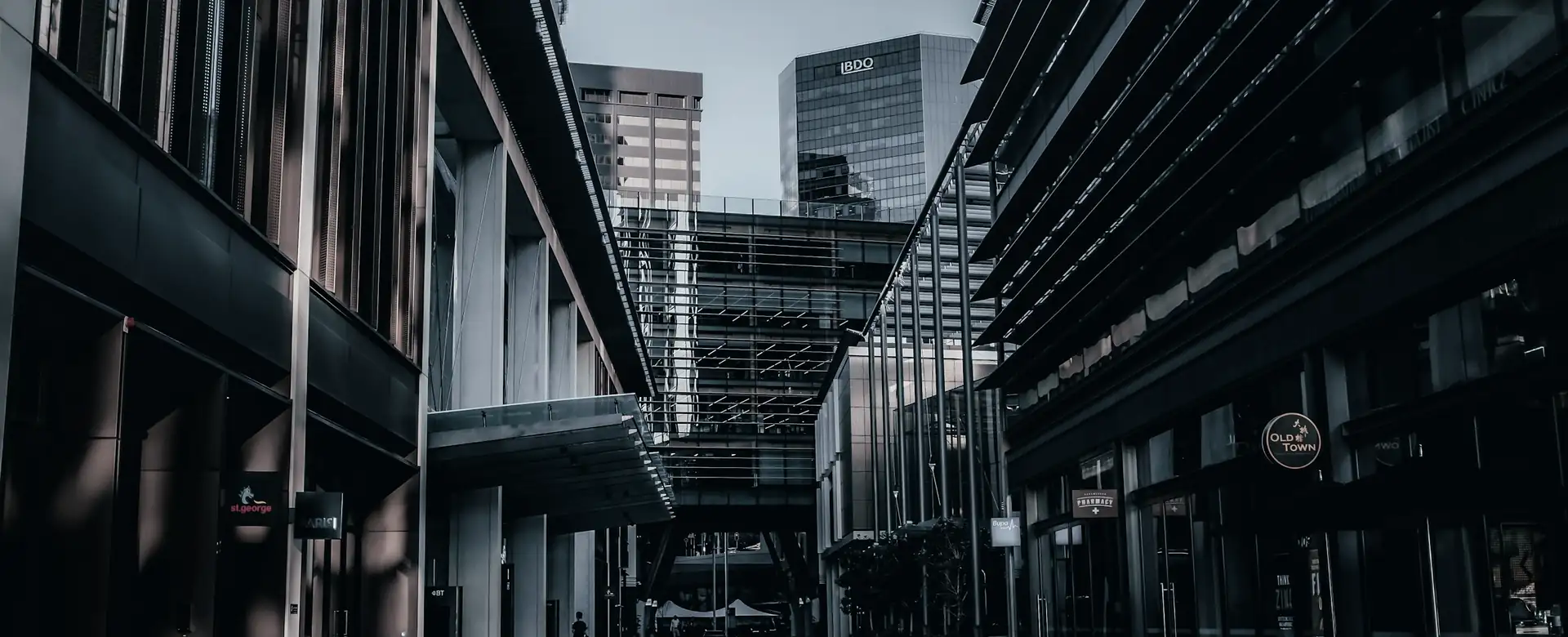 A city lane running between tall office buildings
