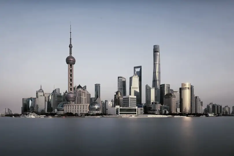 A skyline of towers across a wide river