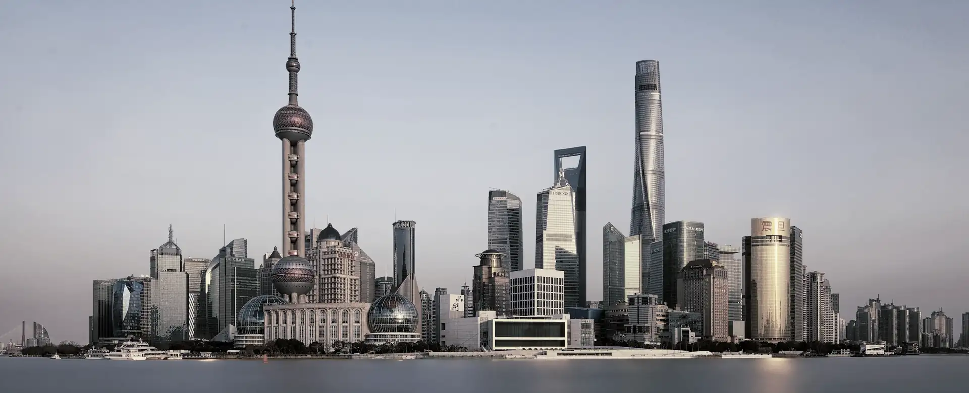 A skyline of towers across a wide river