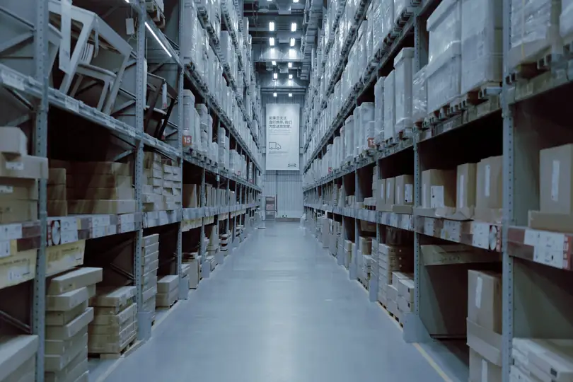 A warehouse aisle between tall shelving