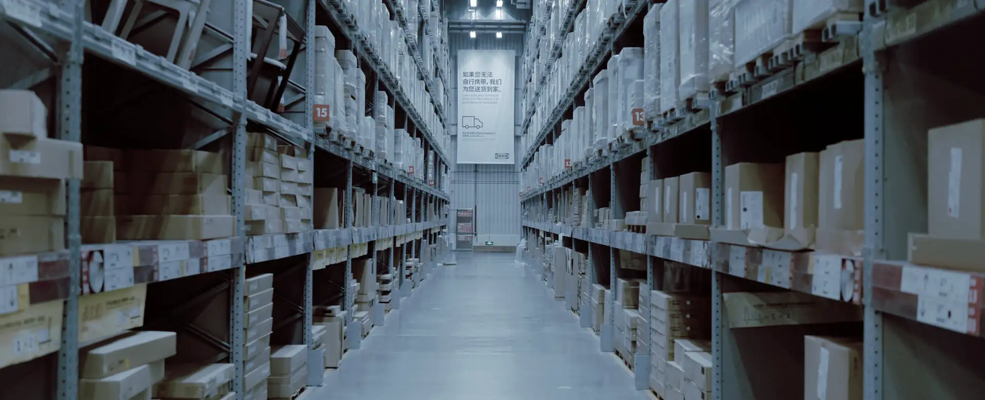 A warehouse aisle between tall shelving